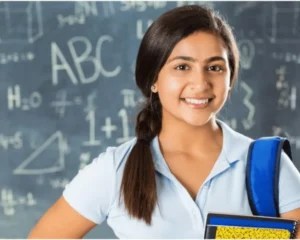 Smiling girl holding a notebook in a classroom
